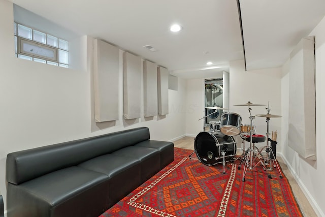 interior space with baseboards, wood finished floors, visible vents, and recessed lighting