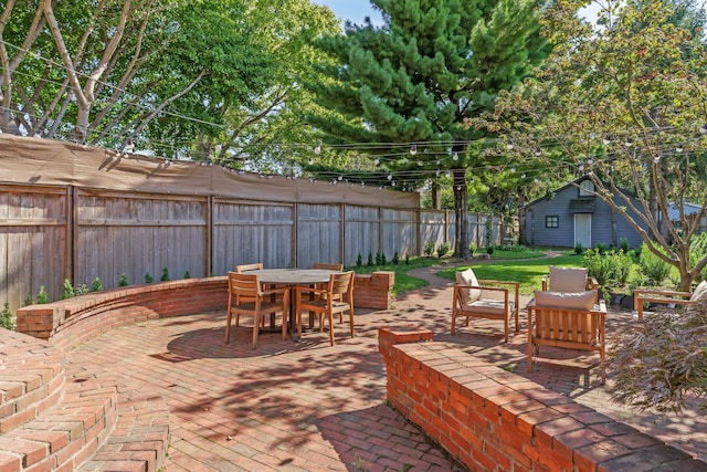 view of patio featuring outdoor dining space and a fenced backyard