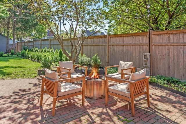 view of patio / terrace with an outdoor fire pit and a fenced backyard