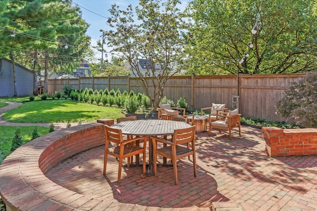 view of patio with an outdoor fire pit and fence