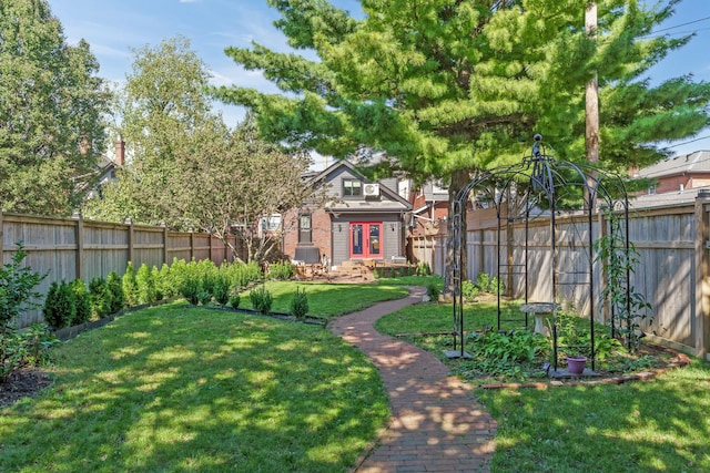 view of yard featuring french doors and a fenced backyard