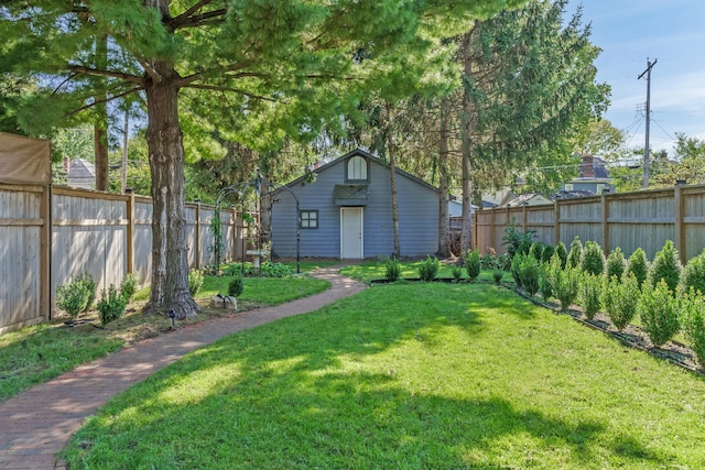 view of yard with a fenced backyard and an outdoor structure