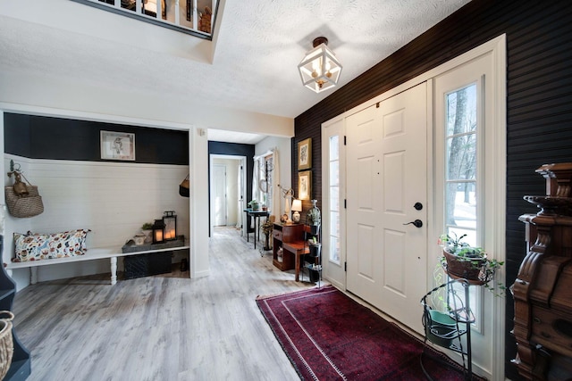 entrance foyer featuring a textured ceiling and hardwood / wood-style floors