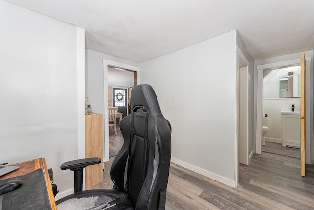 home office with hardwood / wood-style floors