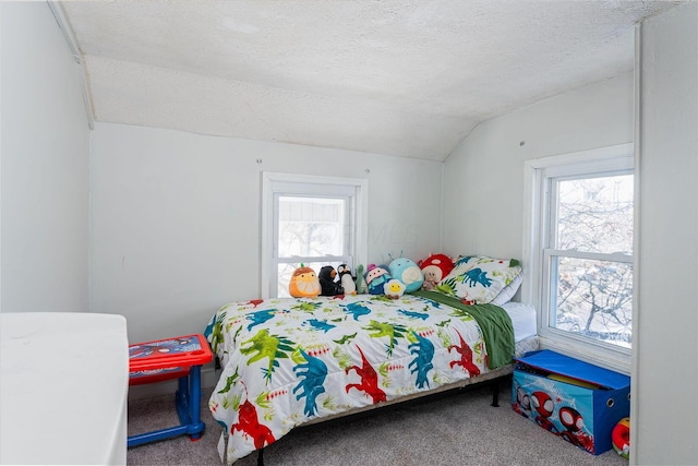 bedroom featuring carpet flooring, a textured ceiling, and lofted ceiling