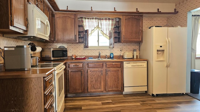 kitchen featuring dark hardwood / wood-style flooring, sink, white appliances, and decorative backsplash