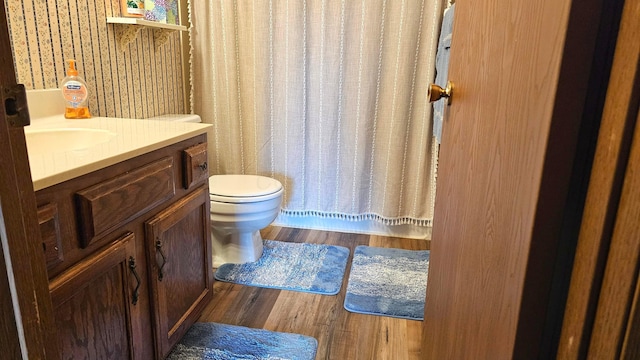 bathroom featuring vanity, toilet, and hardwood / wood-style floors