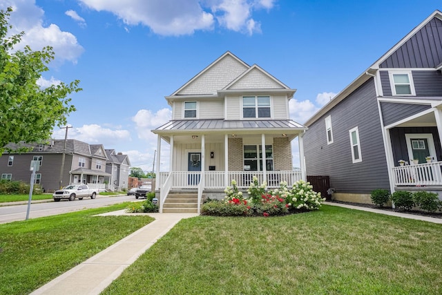 view of front of property with a front yard and covered porch