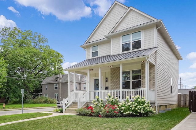 view of front facade with covered porch and a front lawn