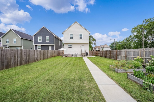 rear view of house featuring a yard