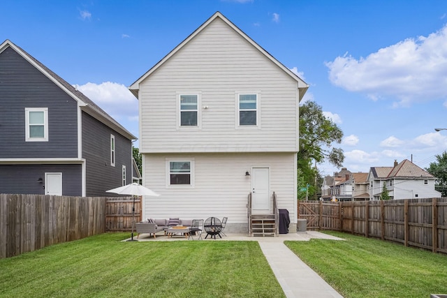 back of house with a yard and a patio