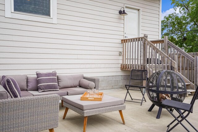 wooden deck with outdoor lounge area and a patio