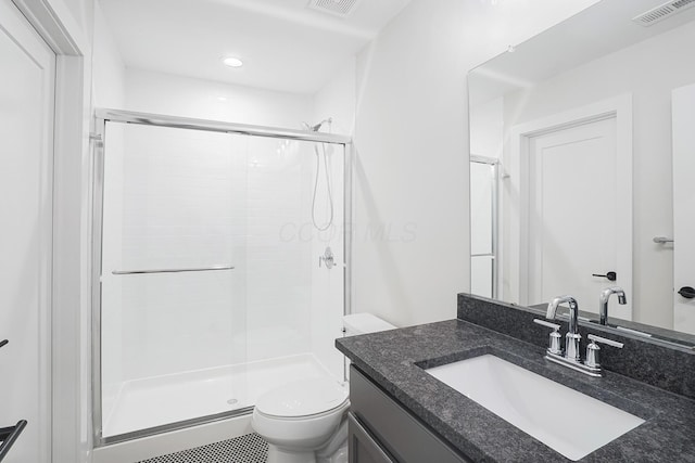 bathroom with vanity, toilet, and walk in shower