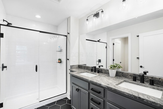 bathroom with vanity, tile patterned flooring, and walk in shower