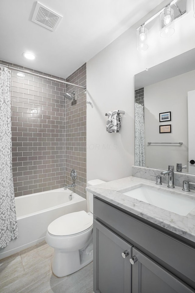 full bathroom with vanity, shower / bathtub combination with curtain, tile patterned floors, and toilet