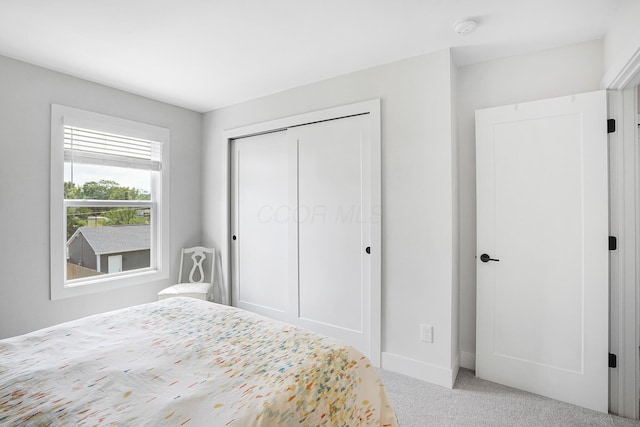 carpeted bedroom featuring a closet