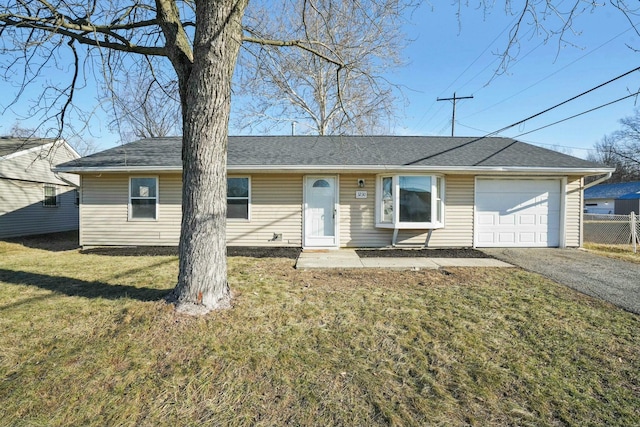 ranch-style home with a front lawn and a garage