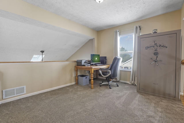 carpeted office featuring visible vents, vaulted ceiling, a textured ceiling, and baseboards