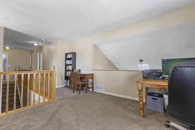 office area with baseboards, visible vents, a textured ceiling, and carpet flooring