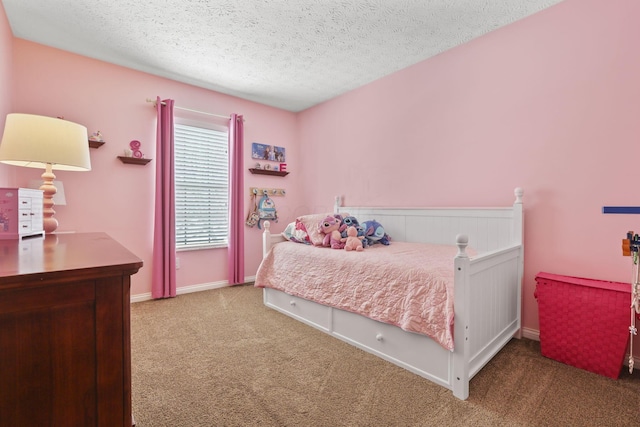 bedroom featuring a textured ceiling, carpet, and baseboards