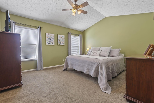 bedroom featuring a textured ceiling, carpet floors, a ceiling fan, baseboards, and vaulted ceiling