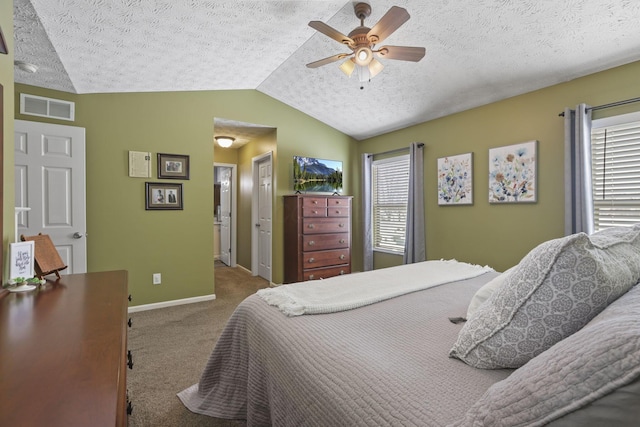 bedroom featuring multiple windows, visible vents, vaulted ceiling, and light colored carpet