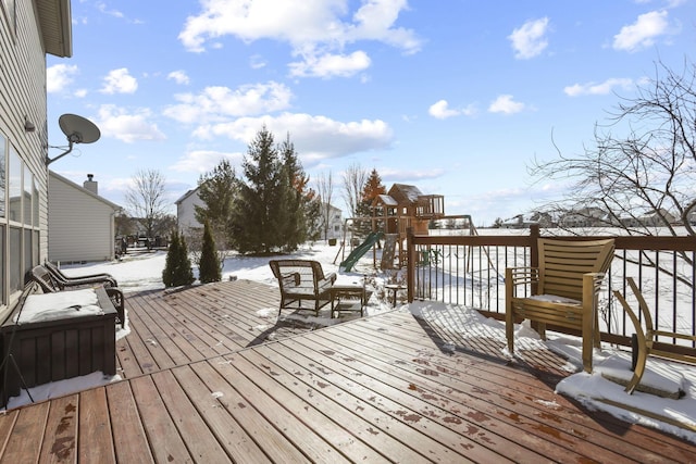 snow covered deck featuring a playground