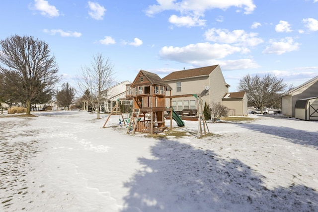 snow covered playground featuring a playground