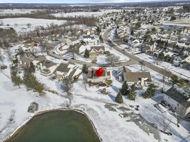 snowy aerial view with a residential view