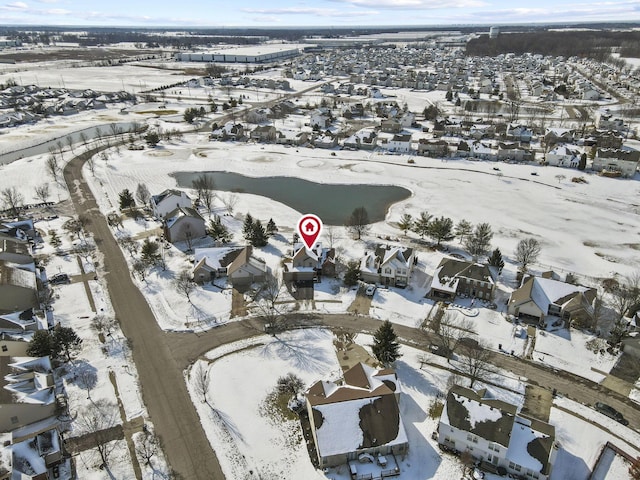 snowy aerial view with a residential view