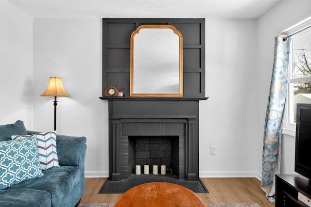 living room with hardwood / wood-style flooring and a fireplace