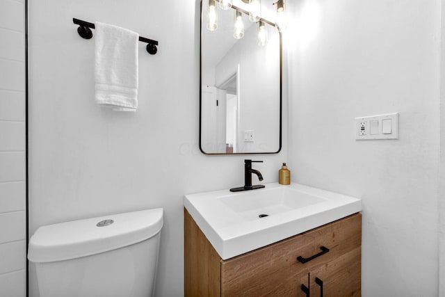 bathroom featuring toilet and vanity