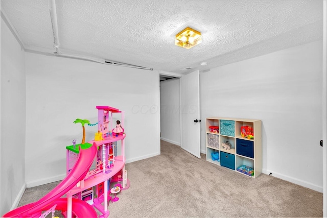 game room featuring carpet and a textured ceiling