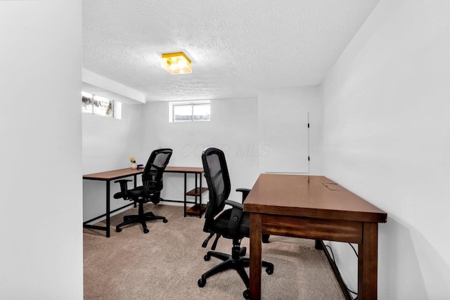 home office featuring light carpet and a textured ceiling