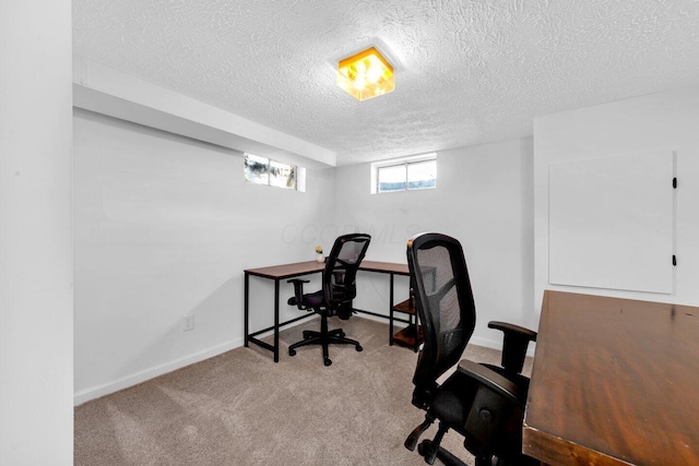 office area with carpet floors and a textured ceiling