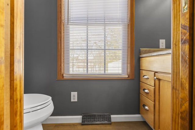 bathroom featuring vanity and toilet