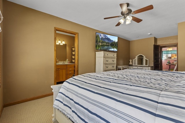 bedroom featuring multiple windows, ensuite bath, light colored carpet, and ceiling fan