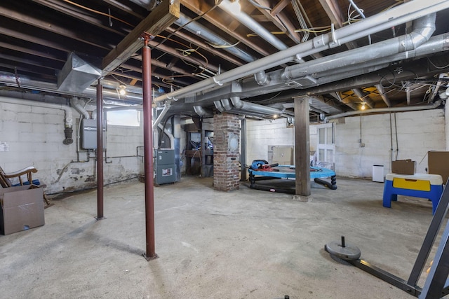 basement featuring heating unit and water heater