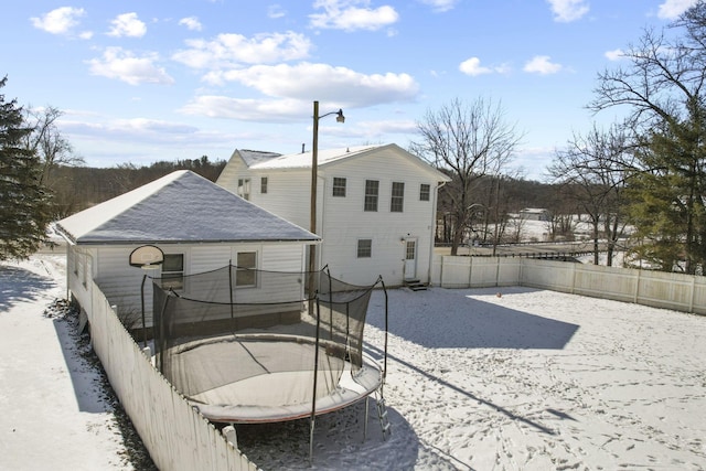 rear view of property featuring a trampoline