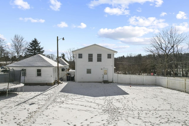 back of house with a trampoline