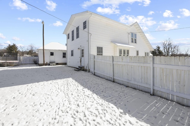 rear view of house with a trampoline