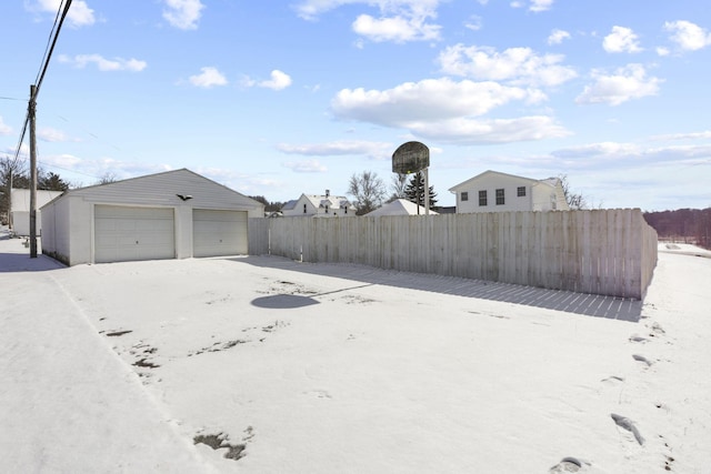 view of yard featuring a garage and an outbuilding