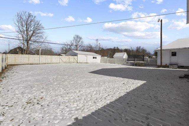 view of yard with a trampoline and an outdoor structure