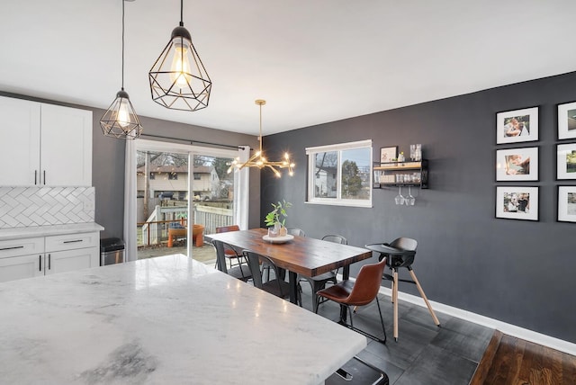 dining area with dark wood finished floors and baseboards