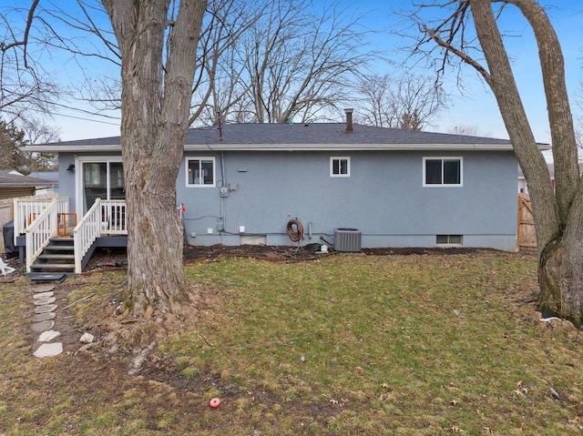 rear view of property with a deck, central AC unit, fence, crawl space, and a lawn