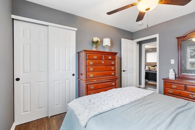 bedroom with a ceiling fan, a closet, and dark wood-style flooring