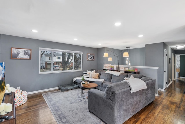 living room featuring recessed lighting, dark wood-style flooring, and baseboards