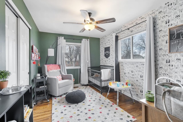 sitting room with wood finished floors, baseboards, and wallpapered walls