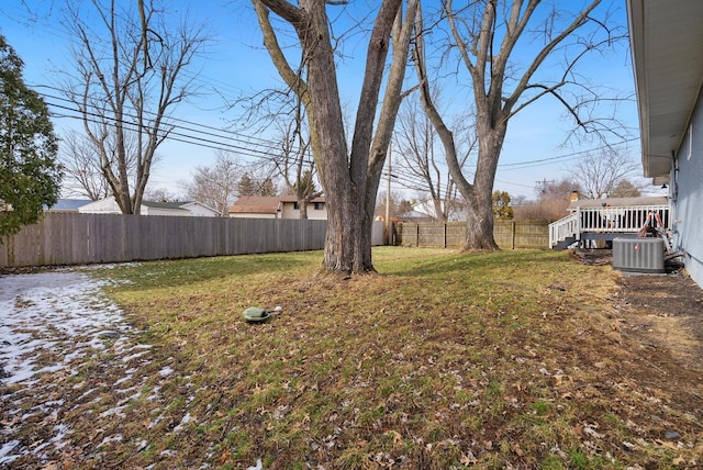 view of yard with a deck, a fenced backyard, and central air condition unit