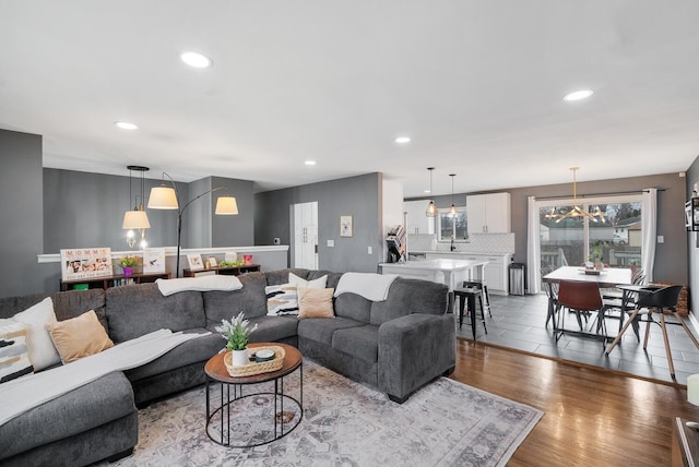 living area with wood finished floors and recessed lighting